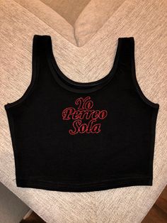 "Super cute bad bunny crop top with \"yo perreo sola\" letters in \"EUTDM\" font super cute for bad bunny's concert or for a gift ! These shirts are pressed professionally so the glitter does not fall off ! ✨ ** DISCLAIMER shirts have a snug fit so if in doubt size up !" Trendy Letter Print Tank Top For Streetwear, Fitted Slogan Crop Top For Summer, Casual Fitted Slogan Crop Top, Fitted Slogan Crop Top For Streetwear, Fitted Black Crop Top Band Merch, Y2k Crop Top Tank With Letter Print, Summer Slogan Crop Top For Streetwear, Black Cotton Band Merch Crop Top, Trendy Slogan Crop Top For Summer