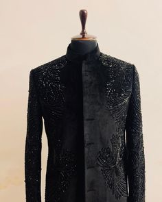 a mannequin wearing a black jacket with sequins on it