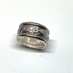 Here is a chunky, wide sterling silver which features a deeply etched floral middle section flanked by classic half-round sterling wires for a ring that it one part antique style and one part modern bohemian!  This ring is 7/16" wide (nearly 1/2"), and will be custom sized up to a 10. Makes a classic band ring, or a great thumb ring, too!  💎 Prefer a narrower but still chunky ring? Here is one with tanzanite: https://www.etsy.com/listing/1753538571/tanzanite-sterling-silver-ring-victorian?ref=l Silver Sterling Silver Engraved Wide Band Ring, Stamped Sterling Silver Wide Band Jewelry, Vintage Silver Engraved Wide Band Ring, Silver Heirloom Wide Band Jewelry, Sterling Silver Jewelry With Decorative Wide Band, Sterling Silver Wide Band With Decorative Design, Silver Heirloom Rings With Wide Band, Silver Artisan Engraved Ring For Anniversary, Silver Heirloom Wide Band Ring