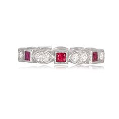 a white gold ring with red and white diamonds