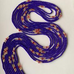 This women's waist bead is a unique and handcrafted accessory that is ready to ship. The beads are made with  blue , gold and red crystal beads, which provide a beautiful and eye-catching appearance. The colors of the beads are the same, but the design may vary, making each strand of waist beads unique and one-of-a-kind. The tie-on waist beads are easy to wear and adjust, ensuring a comfortable fit for the wearer. Each purchase is for one strand of waist beads, which is approximately 60 inches l Blue Waist Beads, Waist Beads, Gold And Red, Handcrafted Accessories, Belly Chain, Natural Curves, Red Crystals, Body Jewellery, Accessories Unique