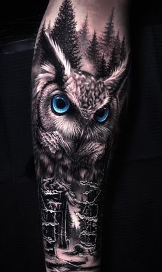 an owl with blue eyes is shown on the arm and leg, in black and white