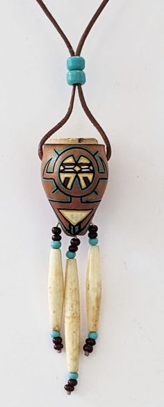 a beaded necklace with two beads hanging from it