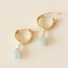 Aquamarine, a water element stone, is a calming stone said to be good for emotional centering. Encouraging selflessness and empathy, this gemstone balances energy and soothes the soul. Crafted with 14k gold filled materials, these minimalist huggie earrings are gentle on the ears and built to last. Match them with any Kindness Gems necklace for a show stopping look! Material | 14k gold filled Stone | Aquamarine Delicate 14k Gold Filled Huggie Earrings For Everyday, 14k Gold-filled Yellow Gold Earrings With Natural Stones, Yellow Gold Gemstone Huggie Earrings For Everyday, Tarnish Resistant Teardrop 14k Gold Filled Huggie Earrings, Dainty Recycled Gold Huggie Earrings, Minimalist 14k Gold Earrings With Gemstone, Everyday Recycled Gold Huggie Earrings, Minimalist Gold Huggie Earrings With Gemstone, Small Hoop Birthstone Jewelry For Everyday