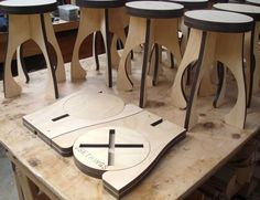 a group of wooden tables sitting on top of a table covered in different shapes and sizes