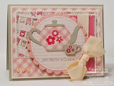 a close up of a card with a teapot on the front and pink gingham background