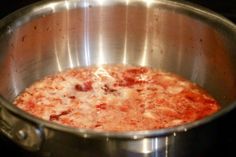 a pan filled with food sitting on top of a stove