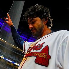 a baseball player holding his hand up in the air