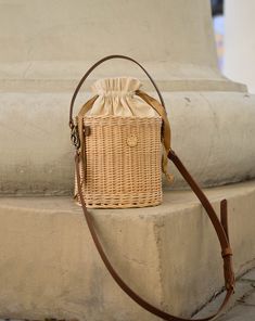 Round wicker basket with adjustable leather long and short straps, have inside cotton bag. It is carefully hand-made by local artisans. This fashionable, stylish and environmentally-friendly basket is perfect for everyday use or going out. Basket have fantastic proportions and handle that perfectly fit into your hand. Wicker basket can be ideal gift for your mum, sister or friend! Features: - a precisely handmade basket made in Lithuania - made from all-natural, eco-friendly and sustainable mate Brown Woven Rattan Bucket Bag, Brown Straw Bag With Bamboo Handle In Bucket Shape, Brown Bamboo Handle Straw Bucket Bag, Spring Handwoven Bucket Bag, Natural Color Bucket Bag For Daily Use, Beige Woven Straw Bucket Bag, Everyday Bamboo Handle Basket Shoulder Bag, Everyday Basket Shoulder Bag With Bamboo Handle, Natural Fiber Bucket Bag