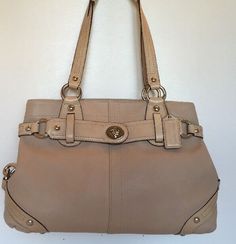 Coach 13236 Handbag Carly color Ivory genuine leather handles Belt- like detail around bag On sides dog leash clasp detail Silver hardware genuine leather handbag One interior zippered pocket Two interior cellphone multifunction pocket preowned very good condition smoke-free Come with dust bag Vintage Beige Shoulder Bag With Branded Hardware, Coach Beige Shoulder Bag With Silver-tone Hardware, Vintage Satchel Tote With Branded Hardware, Vintage Shoulder Bag With Silver-tone Hardware And Double Handle, Classic Beige Satchel With Gold-tone Hardware, Vintage Double Handle Shoulder Bag With Silver-tone Hardware, Classic Beige Shoulder Bag With Gold-tone Hardware, Classic Cream Shoulder Bag With Silver-tone Hardware, Coach Cream Shoulder Bag With Handle Drop