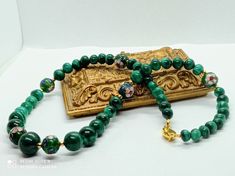 vintage necklace in 24mm malachite beads the largest and cloisonné enamel beads with a 925 silver clasp golden punch, woman Vintage 80-90s Materials: malachite gem, cloisonné enamel beads, silver 925 gold plate Clasp: Typical for China export jewelry, 925G punching Malachite beads round size of beads from 24 mm largest up to 7 mm smallest In all 46 malachite beads All beads have different design and can the shape also that indicates that the beads have made manual! Is in very good condition Gift voucher for women and parties Green Necklaces With 8mm Beads For Gifts, Malachite Necklace With Polished Beads For Gifting, Malachite Beaded Necklace As Gift, Green 8mm Beads Necklace For Gift, Beaded Malachite Necklace For Gifts, Malachite Beaded Necklace For Gift, Vintage Green Beads As Gift, Handmade Gold Necklaces With Malachite, Handmade Elegant Malachite Beaded Necklaces