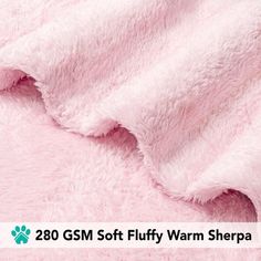 a pink fluffy blanket with the words,'200gsm soft fluffy warm sherpa '