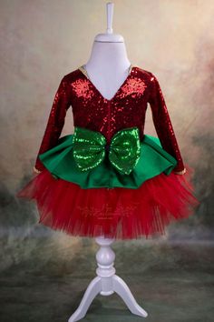 Are you looking for a cute and play friendly party dress for your little girl for Christmas and Holidays? This sweet reindeer Christmas tutu is just perfect for that! It is made of the highest quality satin, sequin, abraham fabric and crystal tulle. It has a V-shape back with a zipper and a big sequin bow. It has a soft satin lining to prevent irritation on the delicate skin of your child. The reindeer headband is included. The Christmas tutu is handmade and will be customized for your little gi Christmas Celebration Dress With Long Sleeves, Red Princess Dress For Christmas Dress-up, Christmas Celebration Long Sleeve Dress, Long Sleeve Christmas Celebration Dress, Red Princess Dress For Dress-up Party Season, Red Holiday Dress With Red Bow, Holiday Red Dresses With Red Bow, Christmas Costume Party Holiday Dress With Long Sleeves, Christmas Long Sleeve Holiday Dress For Costume Party