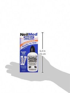 a hand holding up a bottle of neimimed