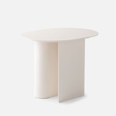 a white table with an oval top on a plain surface, viewed from the front