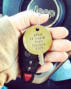 a person holding a car key in their hand with the words home is where they chickens are