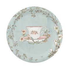 a teacup with flowers painted on it is sitting on a plate that has an oval border around the edge