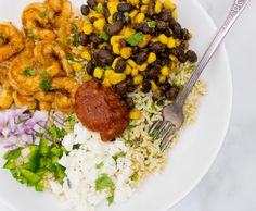 a white plate topped with rice and beans