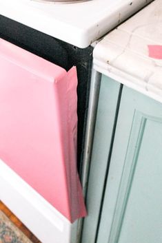 a stove top oven sitting inside of a kitchen next to a counter with a plate on it