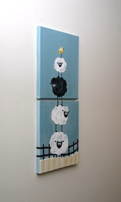 two pieces of art on the wall with sheep painted on them, one is black and white