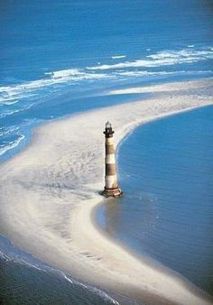 an image of a lighthouse on the beach with caption for pint to win