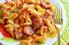 a white plate topped with pasta and meat