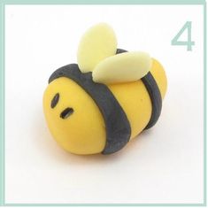 a yellow and black toy with a bee on it's back