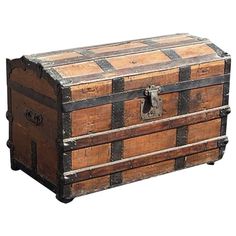 an old wooden chest with metal straps and latches on the top, sitting against a white background