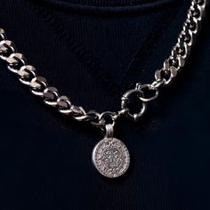 The Coin Chain is made from premium materials designed to last a lifetime. This necklace is water-resistant, heat-resistant, sweat-proof, and can be worn to the gym, out on a run, or even in the shower. The MHART Aztec coin pendant features the historic symbols used to calculate the days, seasons, and years in the Mesoamerican calendar. It consists of a 365 day cycle called Xiuhpohualli, and a 260 day ritual cycle known as Tonalpohualli. Together, these two cycles form a 52 year century. Handmad Symbolic Silver Medallion Necklace Tarnish Resistant, Symbolic Silver Tarnish Resistant Medallion Necklace, Symbolic Silver Medallion Necklace, Symbolic Silver Tarnish-resistant Medallion Necklace, Silver Medallion Necklace With Chain, Silver Tarnish Resistant Coin Medallion Necklace, Silver Tarnish-resistant Coin Medallion Necklace, Silver Medallion Coin Necklace With Chain, Aztec Coin