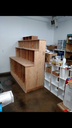 a room filled with lots of shelves next to boxes and other items on the floor