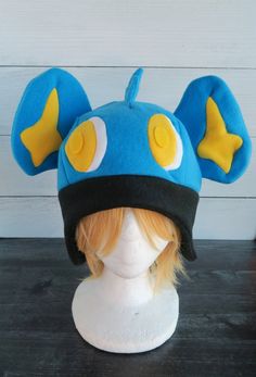 Shinx Pokemon Fleece Hat Novelty Costume Cap Hat, One Size Fits Most Costume Cap For Costume Party, Blue Themed Costume Accessories For Cosplay, Adjustable Blue Costume Accessories For Costume Party, Blue Novelty Costume Accessories Adjustable, Blue Adjustable Novelty Costume Accessories, Novelty Blue Adjustable Costume Accessories, Fun Costume Hats And Headpieces, Themed Brimmed Costume Hats And Headpieces