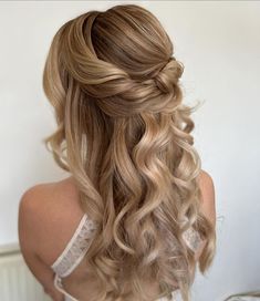 a woman with long blonde hair in a half updo