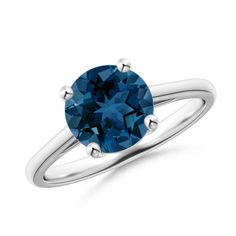 a blue diamond engagement ring on a white background with the center stone set in 18k white gold