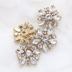 "This crystal shank button adornment can work for dress, hair comb, sash applique, buckle, clutch, ring pillow, invitations, bouquets, pillow case. This gorgeous buckle clasp closure is made by crystals and very sparkling. Best for your sewing project. Properties: metal, wire, faux pearl Color: gold or silver Size: approx. 0.7\", 1.9cm -------------------------------------------------------------------------------------------------------------------------- RETURN POLICY *All broken case can be r Gold Flower Brooch For Wedding, Gold Wedding Brooches In Flower Shape, Gold Flower Shaped Wedding Brooches, Crystal Flower Brooch For Weddings, Gold Flower-shaped Brooches For Wedding, Gold Flower Brooches With Rhinestones, Gold Flower-shaped Wedding Brooches, Gold Crystal Clip-on Earrings With Rhinestones, Wedding Dress Buttons