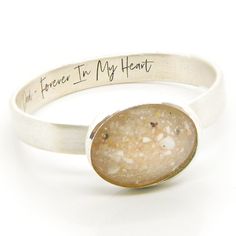 a close up of a ring on a white surface with writing on the front and back