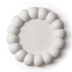 a white beaded bracelet is shown against a white background with space in the middle