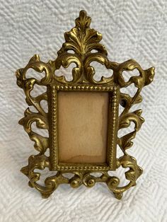 an ornate gold frame on a white background with the image in it's center