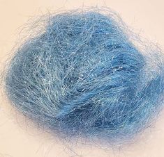 a blue ball of yarn sitting on top of a white table