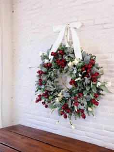 a wreath hanging on the wall next to a wooden bench