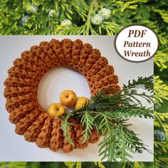 a crocheted wreath with two apples on it and the words pattern wreath above it