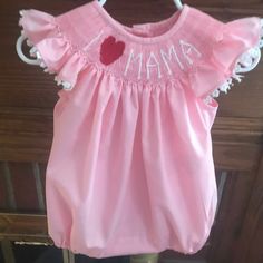 Mothers Day Bubble, hand smocked with white trim around the sleeves. Hand embroidered with your choice. I ❤️MAMA or MOM I ❤️DADDY I ❤️PAPA 2 are available Allow 2 weeks for delivery Cotton Smocked Dress With Ruffles For Baptism, Baptism Short Sleeve Smocked Dress, Baptism Smocked Dress With Short Sleeves, Pink Cotton Smocked Dress For Daywear, Cute Cotton Smocked Baptism Dress, Cotton Smocked Dress For Baptism, Short Sleeve Smocked Dress For Baptism, Fitted Pink Embroidered Smocked Dress, Fitted Pink Smocked Dress With Embroidery