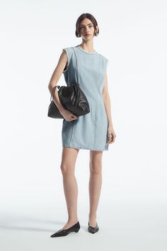 This paneled mini is our womenswear team's contemporary take on '60s shift dresses. It's crafted from organic-cotton denim that's blended with fluid TENCEL™ Lyocell and has a round neck, a tasseled zip pull and modern frayed edges. Complement the short hemline by styling it with knee-high boots. Slim fitZip closureOrganic cotton is grown from non-genetically modified seeds without chemical fertilizers or pesticides Shell: 62% Organic cotton, 38% TENCEL™ Lyocell. Excluding trims / Machine wash Ba Summer Denim Mini Dress For Work, Summer Workwear Denim Mini Dress, Relaxed Fit Mini Denim Dress For Work, Relaxed Fit Knee-length Mini Dress For Work, Mini Length Denim Dress For Daywear, Mini Denim Dress For Daywear, Denim Mini Dress For Daywear, Denim Mini Dress With Relaxed Fit, Spring Mini Length Denim Dress For Workwear