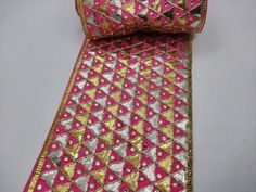 artisanal handcrafed geometric triangular gota patti embroidered carrat pink indian wedding sari costume border edging trimming by the yardWidth: 4.5 inchesThis lace ribbon trim can be used in :-dress edging, scarves and veils- traditional Indian outfits( saree, blouses, dupattas, kurti etc)-crafting headband, hats-table runner, curtains-jewelry making,-for making belt-floral arranging-waist belt to add grace plain outfit-trimming shrugs, skirts, tunics,-embellishing festive wear, wedding wear, Pink Festival Dupatta For Party, Pink Party Festival Dupatta, Pink Dupatta With Border For Festivals, Party Dupatta With Border For Festivals, Pink Bollywood Dupatta With Border, Bollywood Style Pink Dupatta With Border, Pink Border Dupatta For Diwali, Pink Dupatta With Border For Diwali, Pink Dori Work Dupatta For Festival