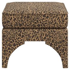 a leopard print foot stool sitting on top of a white floor