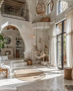 a living room filled with lots of furniture and decor on top of a white floor