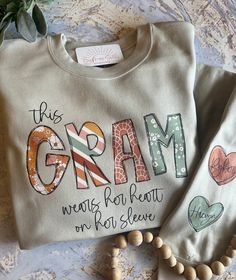 This Grandma Wears Her Heart On Her Sleeve, Grandma Sweatshirt Ideas, Cotton Pre-shrunk Sweatshirt As Gift, Personalized Tops As Fall Gifts, Custom Print Long Sleeve Cotton Sweater, Long Sleeve Cotton Sweater With Custom Print, Fall Gift Sweatshirt With Custom Print, Custom Print Sweatshirt For Fall Gift, Personalized Long Sleeve T-shirt