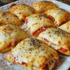 several pieces of pizza on a plate with cheese and pepperoni toppings, ready to be eaten