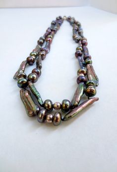 "What a beautiful, Vintage, color enhanced, Fresh Water Pearls and sterling silver beaded, double strand necklace. The fascinating clasp is stamped 925. The iridescent necklace measures: 20.5\". It's in great condition. Please see photos. This luscious piece of rare jewelry ships FREE within one to two business days. Please feel free to contact me prior to purchase to ask any questions you may have. Follow us on FB at Jackpot Jen Vintage. Thank you for your interest! Jackpot Jen Vintage 6932/21/ Silver Pearl Necklace With Colorful Beads As Gift, Iridescent Polished Round Beads Jewelry, Iridescent Jewelry With Polished Round Beads, Elegant Multi-strand Pearl Necklace With Colorful Beads, Silver Double Strand Pearl Necklace, Silver Pearl Necklace With Colorful Beads, Artisan Double Strand Silver Necklaces, Artisan Double Strand Silver Necklace, Iridescent Spacer Beads For Jewelry Making