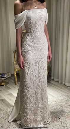 a woman in a white wedding dress posing for the camera with her hand on her hip