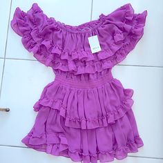 Never Worn, Tags Still On - Adorable Yet Sexy Magenta Dress. Detailed With Layered Ruffles And A Band Around The Waist To Enhance Your Curves. Purple Ruffled Hem Dress For Party, Purple Dress With Ruffle Hem For Party, Purple Ruffle Hem Mini Dress For Summer, Chic Purple Mini Dress For Summer, Chic Purple Mini Length Dresses, Chic Purple Mini Dresses, Fitted Purple Ruffle Dress For Party, Fitted Purple Dress With Ruffled Skirt, Elegant Purple Dress With Ruffled Skirt